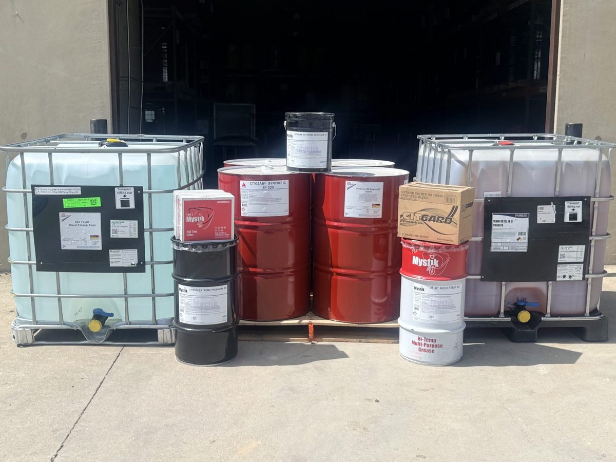 Lubricant drums, pails, and totes staged in the DIAL Lubricants warehouse